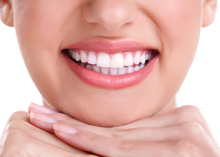 Close-up of a woman’s bright white smile, showing straight teeth and healthy gums.