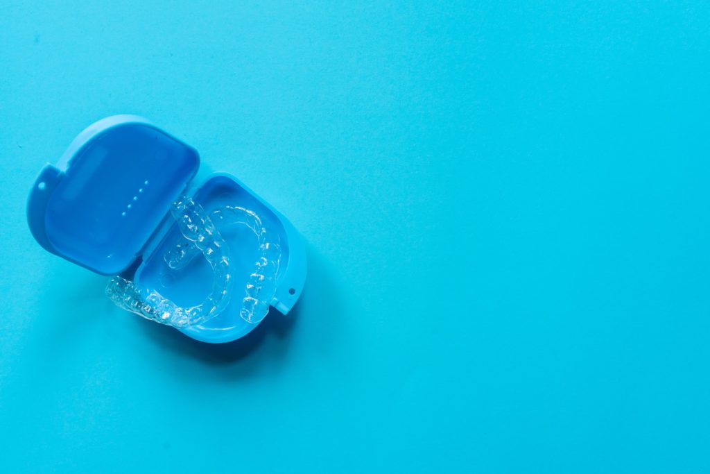 Invisalign option to braces in an Invisalign holding case to represent Invisalign services at capital dental in lincoln nebraska