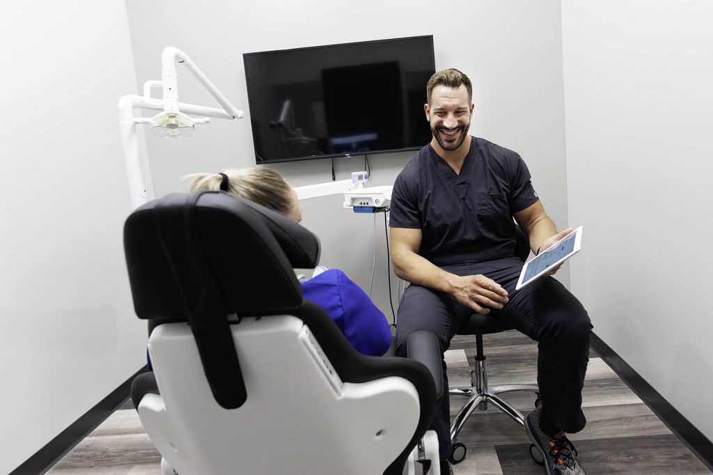 Dr Brandon Chapek of Capital Dental discussing Progress with a dental patient in their office at 5609 South 27 street Lincoln Nebraska