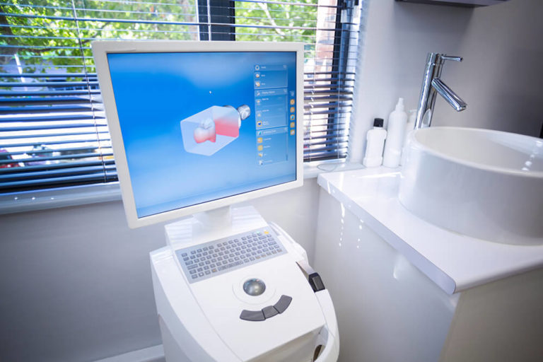 iTero Digital Scanner machine in a dental office next to a counter with a sink
